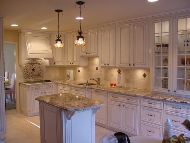The white kitchen above shows our custom hood and a custom island in Cherry Hill, NJ with kitchen storage solutions for easy meal preparation.