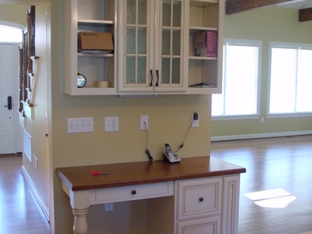 Our custom desk area in the kitchen in West Chester, PA, using available space for organization in this downsize home in the West Chester, Malvern area.