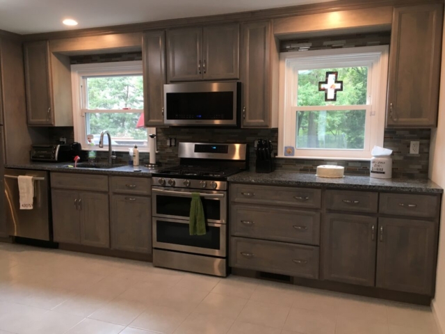 Gray stained cabinets with a gray and black granite counter top and stainless steel appliances in Bucks County, PA