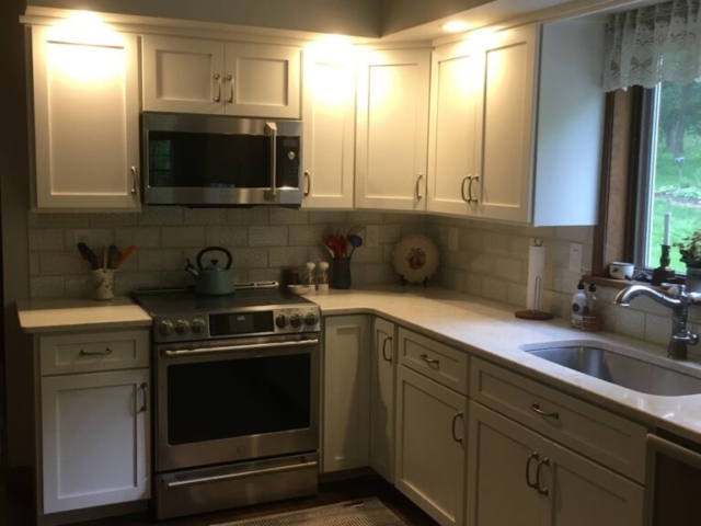 Custom Kitchen Cabinet Refacing with White Flat Panel Doors and Custom Cabinetry Storage