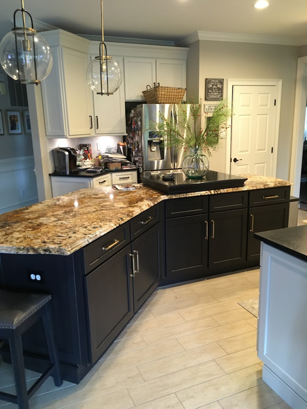 A beautiful contrast was created when this custom kitchen cabinet refacing was completed with the main cabinetry in a white paint finish and the island alternatively finished with a dark stain.