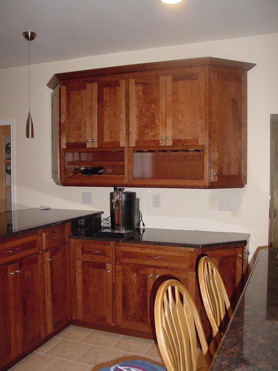 This Doylestown, New Britain, area shows a wall cabinet with wine bottles and glass stems area to give this kitchen a great custom area with all the added convenience to make cooking in your kitchen a pleasure.