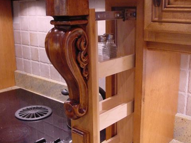 This Mount Laurel, NJ, shows custom pull out spice rack, a maple wood hood, giving this kitchen quick access to your most used items in the kitchen.