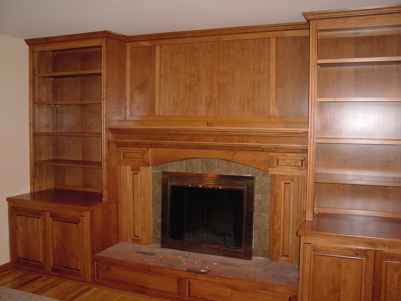 Our custom cherry wood stained cabinets in the family room, fireplaces with built-in bookcases in Upper Makefield, Washington Crossing area of Bucks County gives this large family much-needed storage.