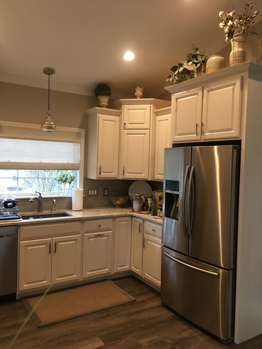 Beautiful White Kitchen Remodel, Decorative Tile Backsplash, Glass Front Door, Decorative Hood and Stainless Steel Appliances
