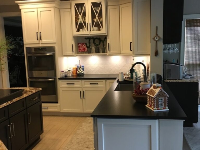 Main cabinets were finished in a white paint with glass door accents in this custom kitchen cabinet refacing transformation.