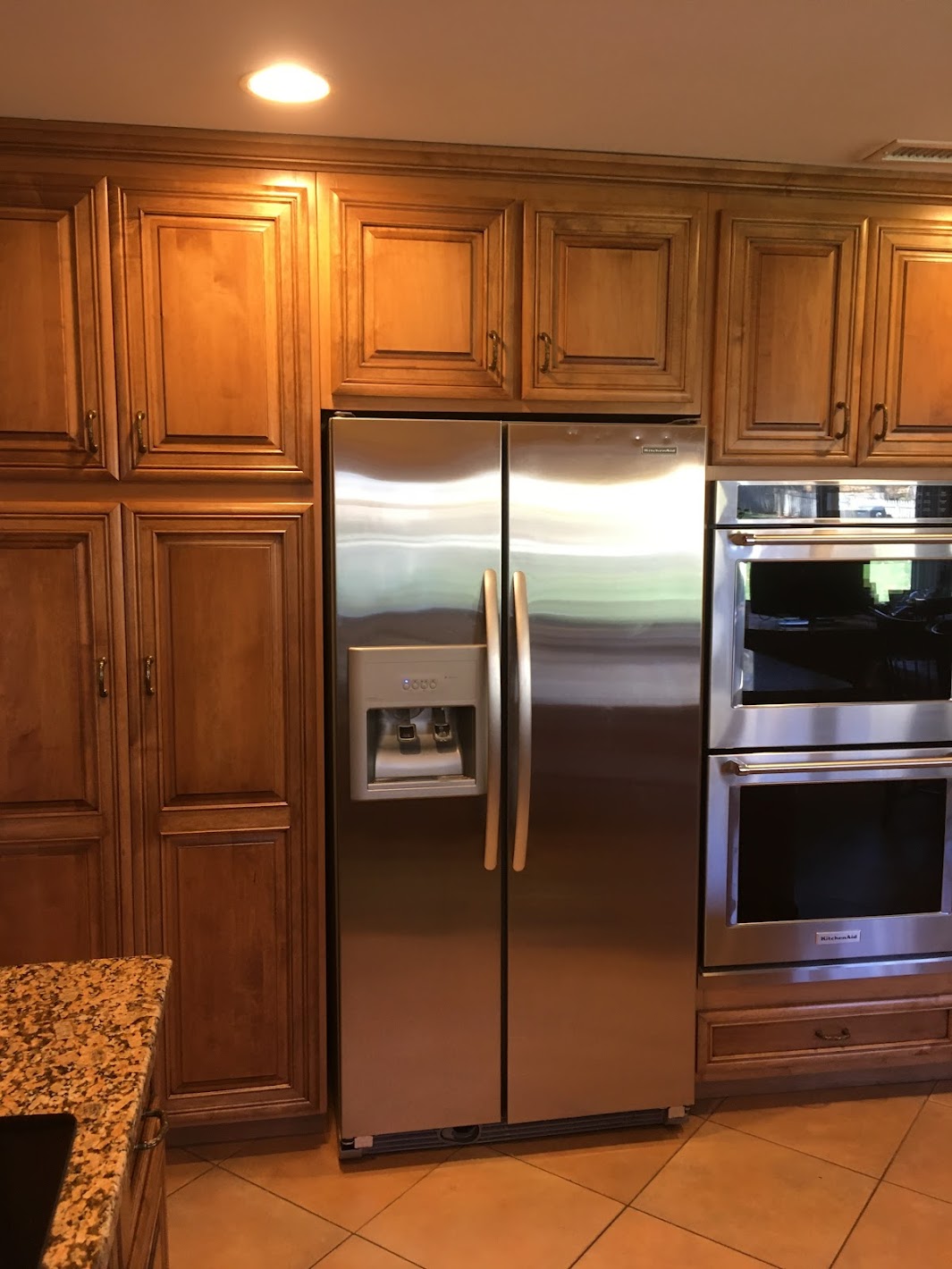 A beautiful kitchen remodel completed with maple wood with raised panel doors and matching drawers.