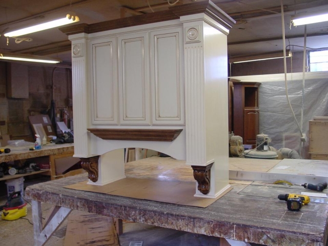 Custom Range Hood with a White Antique Finish Accented with a dark wood stain
